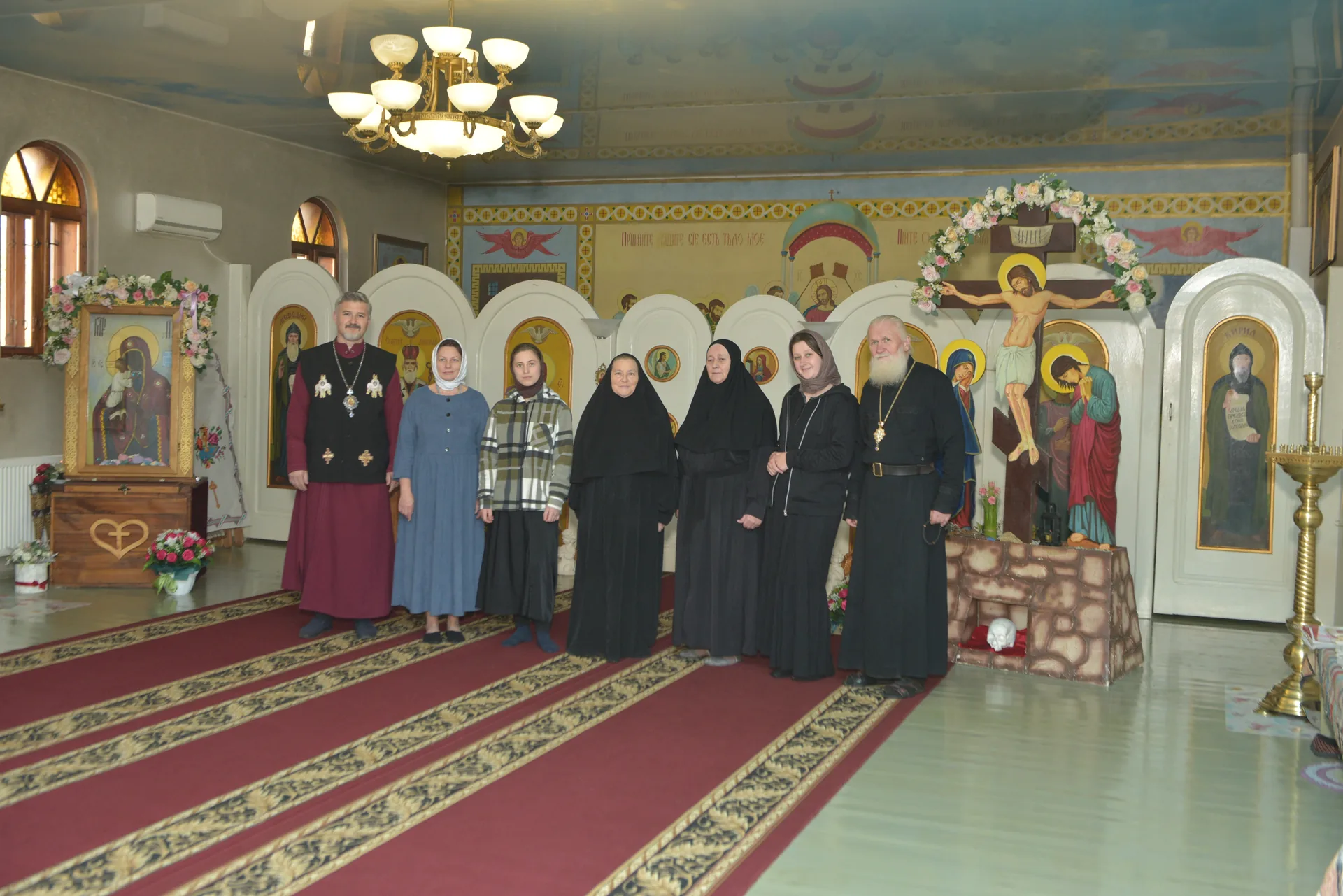 A community group photograph in front of the iconostasis