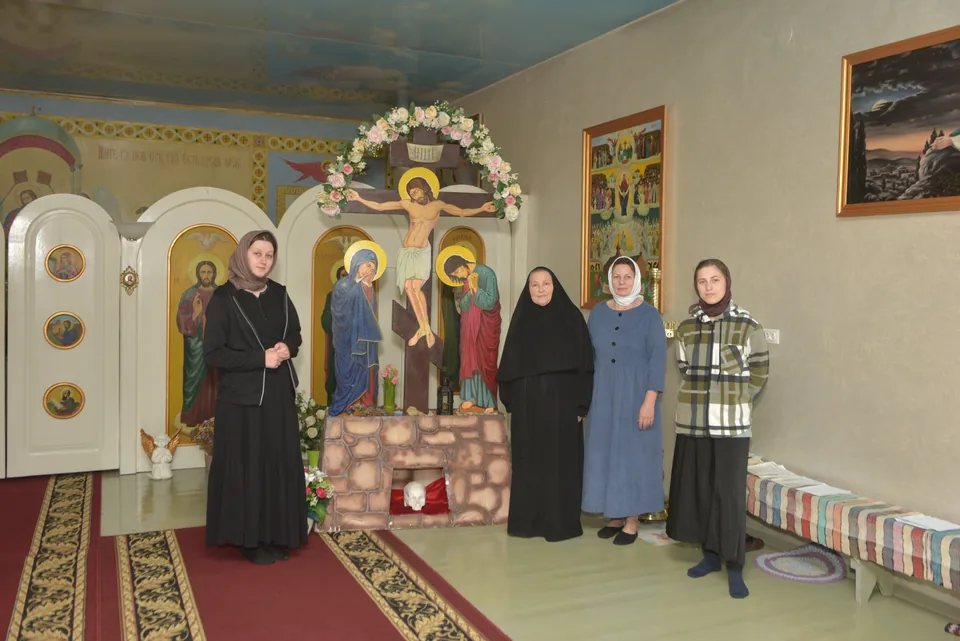 Community sisters in the church in front of icons