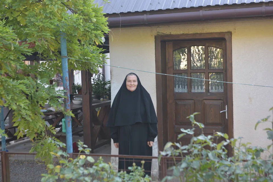 A community sister beside the entrance to the social kitchen building